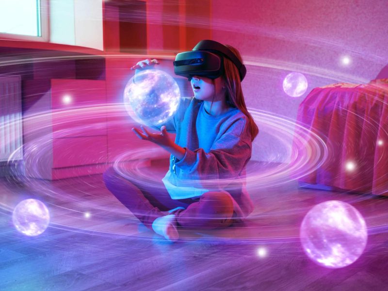 Child,Girl,Wearing,Virtual,Reality,Headset,And,Looking,At,Digital